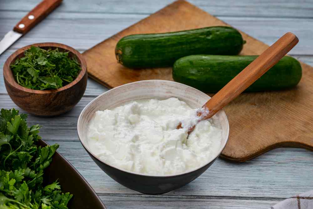 <a href="https://www.freepik.com/free-photo/front-view-cucumbers-board-with-yogurt-greens-gray-surface_9635071.htm#query=yogurt&position=30&from_view=search&track=sph">Image by stockking</a> on Freepik