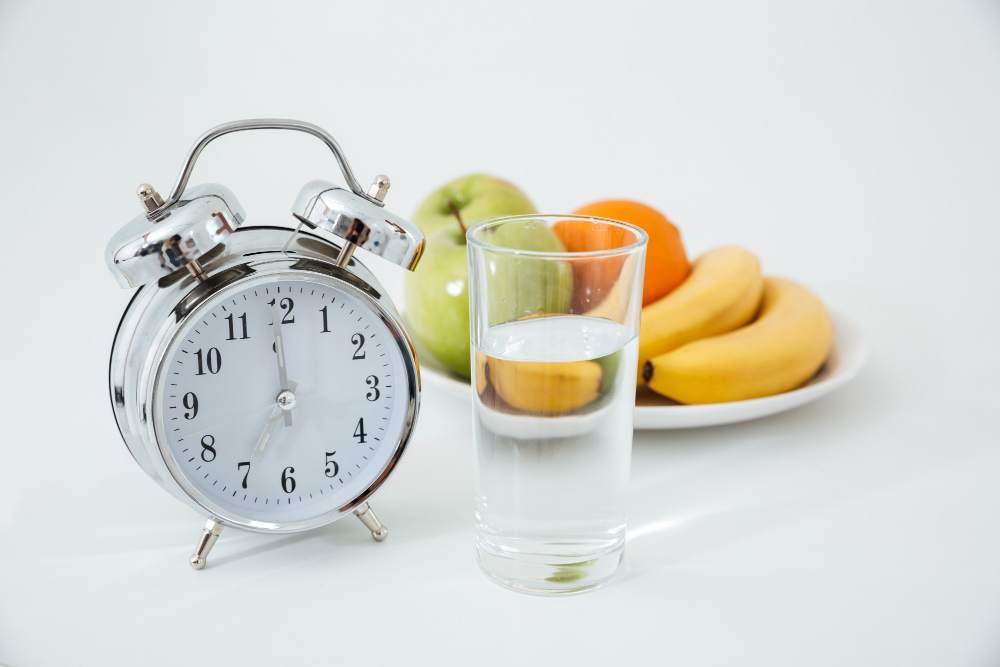 <a href="https://www.freepik.com/free-photo/alarm-glass-water-near-fruits_7836209.htm#query=FASTING&position=10&from_view=search&track=sph">Image by drobotdean</a> on Freepik ( intermittent fasting)