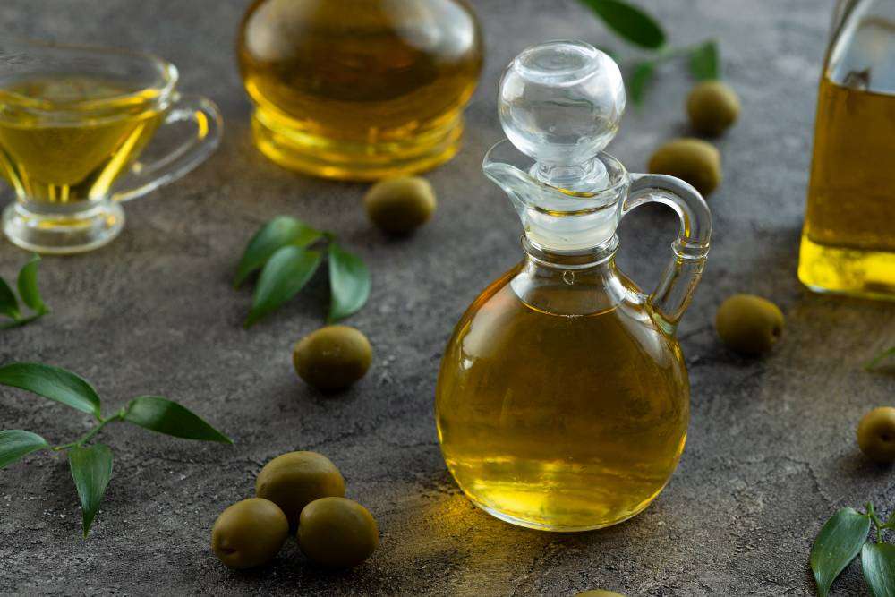 Image by <a href="https://www.freepik.com/free-photo/high-view-bottles-filled-with-olive-oil-marble-background_5486622.htm#query=Olive%20Oil&position=31&from_view=search&track=ais">Freepik</a>